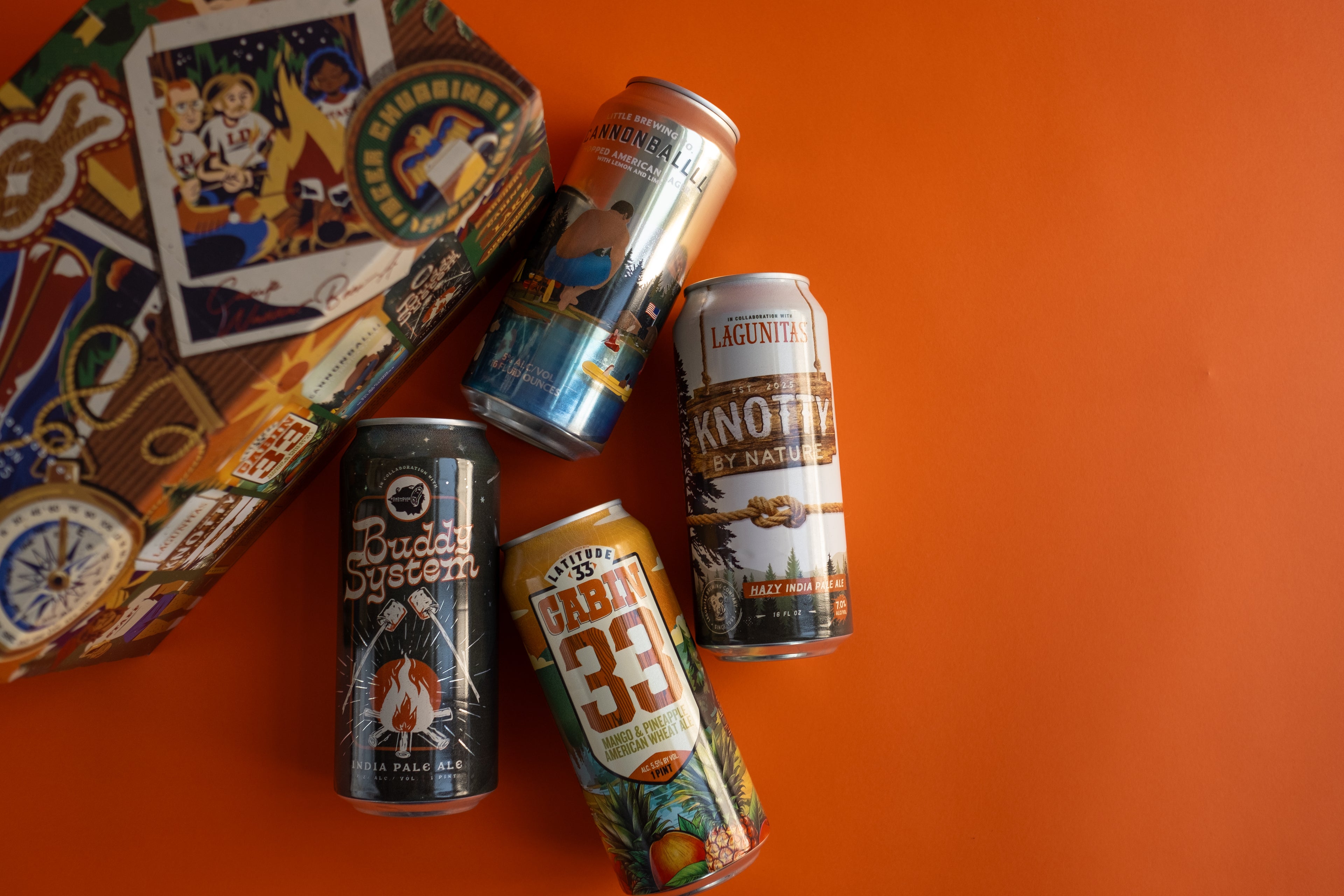 Collection of beer cans on an orange background